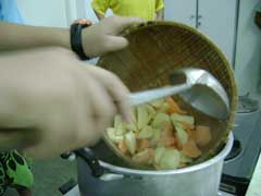 putting potatoes into boiling syrup