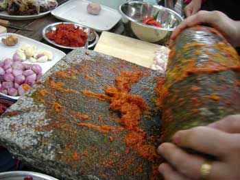 Grinding spices in my cooking class in the Tropical Spice Garden Penang